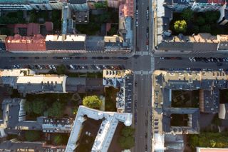 Flygfoto över en stad –&nbsp;bostäder, gator med parkering. Foto Adam Blomberg.